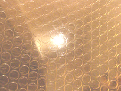 The boy in the plastic bubblewrap.