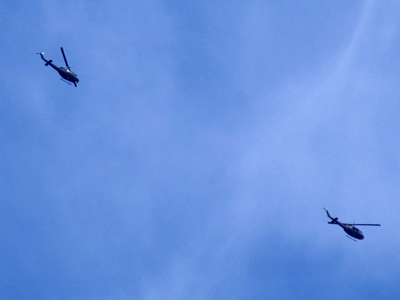 What are two Army helicopters doing over an Air Force town?