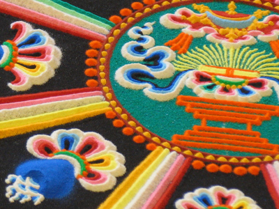 The monks are creating a mandala of colored sand.