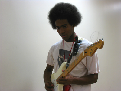 `The practice rooms are too small,` explained this hallway-roaming guitarist.