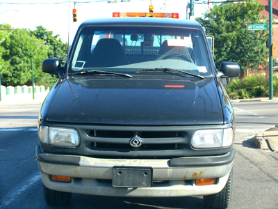 I happened to drive behind an abandoned truck being towed away.  It had a small tree in the back (see August 7).