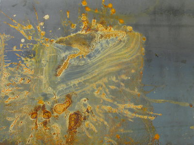 An abstract expressionist painting, or a water-damaged ceiling panel.