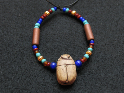See what I made today?  It`s a genuine Egyptian scarab beetle, with genuine domestic beads.