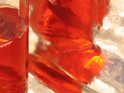 A glass of raspberry juice, on the underside of a piece of wrapping paper, inside the refrigerator -- obviously.