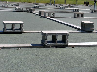 Tennis court maintenance resembles minimalist sculpture.
