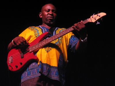  . . . while guitarists step and strut as they play.