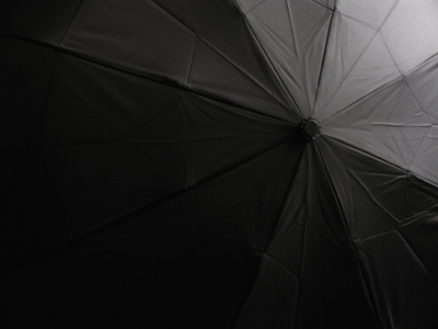We call it `umbrella` (little shadow).  The French say `parapluie` (rain shield).