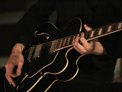 Check out Guitar George: he knows all the chords.  But it`s strictly rhythm - he doesn`t want to make it cry or sing. DIRE STRAITS