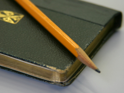 Pencil and prayer book.