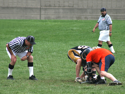 There were three referees on the field, but they did little but watch the players club and beat each other.
