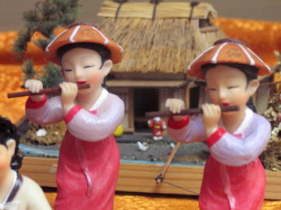 Two women playing wind instruments.