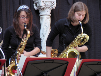 Two women playing wind instruments.