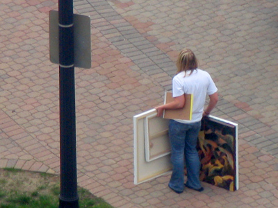 Recent art grad awaits bus to success.