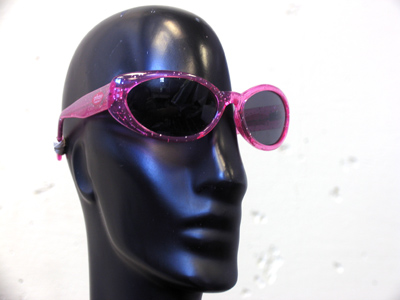 Reflected in the glasses is a little boy who was hovering around and giving me very strange looks.