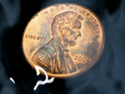 In the bottom of a fountain:  the squiggle is a reflection off the water rushing past.