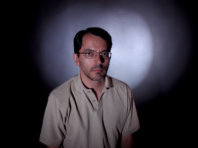 Assignment 3:  circle of light on a dark background with an illuminated person in front of it.