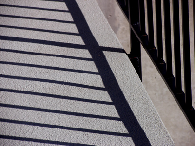A black fence casts black shadows.  What if it was red?