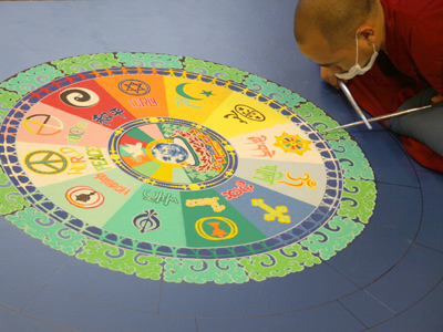 Creating a mandala is a form of meditation for a Buddhist.  Meanwhile, the woman next to me was saying, `Sir?  Is that some kind of zodiac?  SIR!?  What are those symbols?`