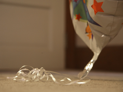 A month later, my belated balloon prowls the floor instead of the ceiling (see June 22, 2009).