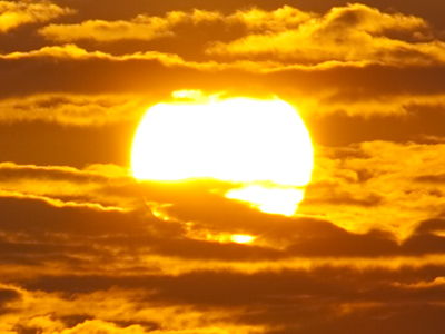 What intrigues me about shots like this (and October 15, 2008) is that some clouds seem to be behind the sun.