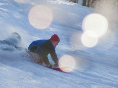 This picture of a kid sledding down a hill was the result of significant effort and patience on my part.  The sun sparkles, on the other hand, were a fortunate accident.