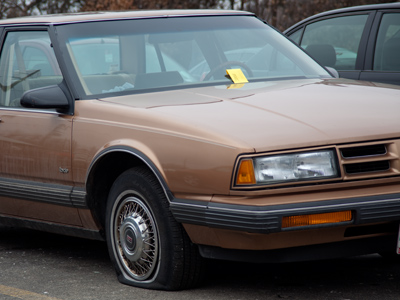 A flat tire AND a parking ticket.  Maybe it`s out of gas, too.
