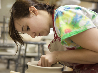 She had finished working on her pottery piece, but she kindly put it back onto the wheel for my amusement.