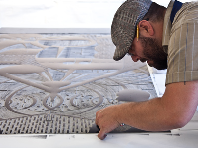 Printmaking with Ryan McCullouh, Step One:  Carefully cut a reverse image original.