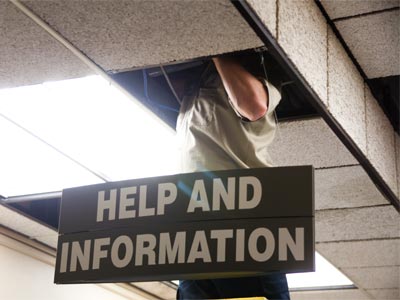 A little while later, the fallen ceiling tiles were swept up and put into a bag marked DANGER: ASBESTOS.
