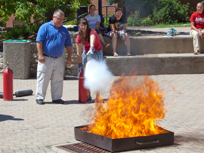 As luck would have it, a nearby student is taking her fire extinguisher for a walk.