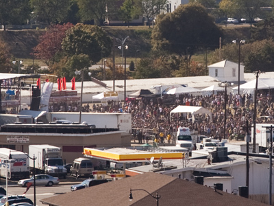 While twenty people listen to jazz inside, thousands crowd the nearby fairgrounds to hear rock.