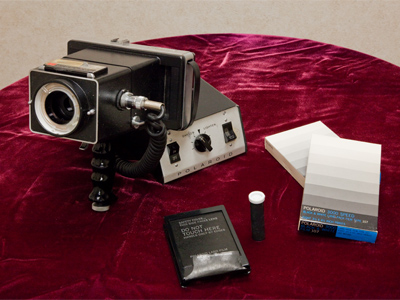 Today while cleaning cabinets in the Library, this old Polaroid camera was found, with boxes of unopened film.