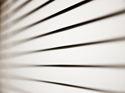 People drive past frantically as I wander a park aimlessly.