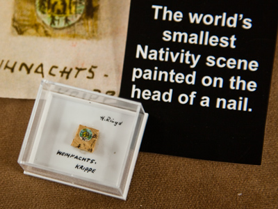 This is in a display case near my office, so every day I hear people shout to their companions, `Look!  It`s the world`s smallest nativity painted on the head of a nail!`