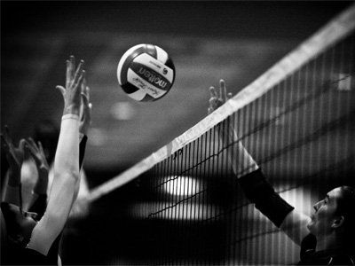 Fourteen courts are going at the same time, so I go to one in the corner where I can safely put my back to the wall.