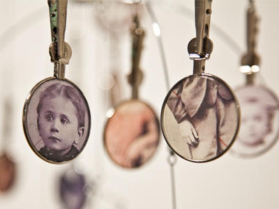 `Held in Silence` (mobile with antique lenses) by Deborah Barr, now on display at the Dayton Visual Arts Center.