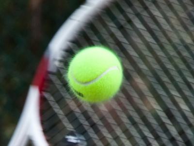 In this picture and others, I noticed that the little fuzzy hairs on a tennis ball extend outward when it`s flying in the air.