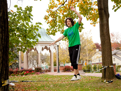 Unknown person suspended between two trees.