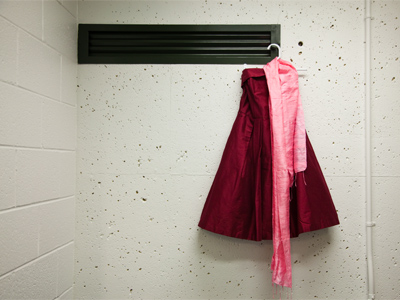 The diva prepares for a big concert in a practice room.  The dress got cupcake icing on it, but the show goes on.