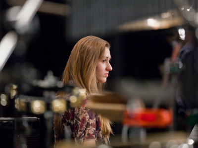 Surrounded by an arsenal of percussion instruments.