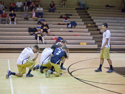 The player on the right served for nine points in a row, so he deserved the obeisance of his teammates.