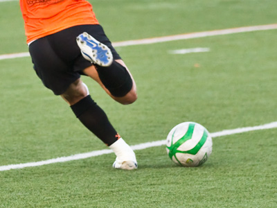 Spectators sat on the other side of the field in the hot sun.