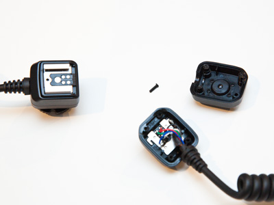 The broken flash cable that cost $85 is on the right (see August 2 and 3 above).  The $15 replacement cable on the left is reinforced so it won`t break.