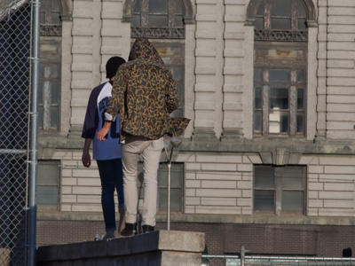 Shooting safely and legally from the sidewalk, I met two camera commandos who decided to jump the fence.