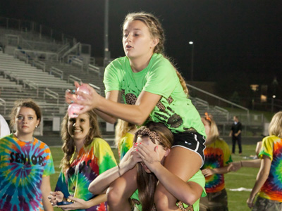 The lower teammate REALLY hoped the upper teammate caught the water balloon.