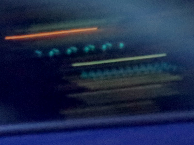 The instrument panel of a passing car.  Part of it glowed steadily while another flashed six times in 1/25th second.