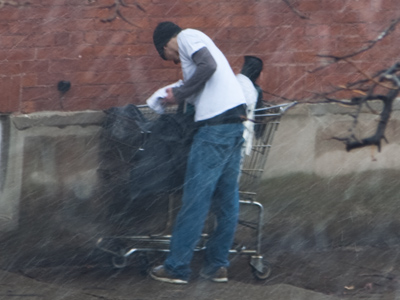 It suddenly began snowing heavily, so this guy stopped to put a white t-shirt over his gray long-sleeved shirt.