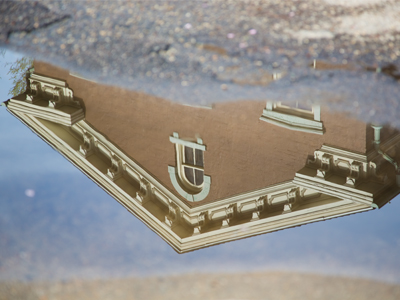 An old building in a new puddle.