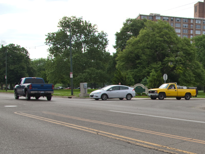 The person in the yellow truck blew the horn repeatedly, trying to intimidate the other driver to pull out into traffic.