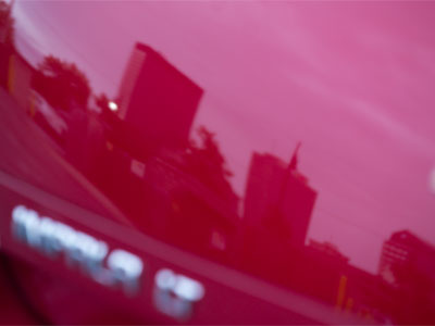 The city of Dayton, reflected in a red Impala.
